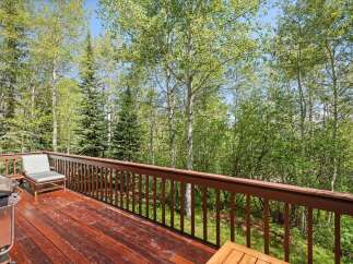 Enjoy the serene mountain views from this spacious deck, perfect for outdoor entertaining or quiet relaxation.