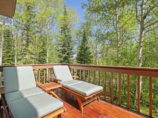 Enjoy the serene mountain views from this charming deck, perfect for relaxing or entertaining.