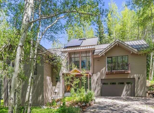 Nestled amidst a serene aspen grove, this stunning mountain home offers a perfect blend of modern luxury and natural beauty.