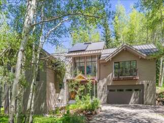 Nestled amidst a serene aspen grove, this stunning mountain home offers a perfect blend of modern luxury and natural beauty.