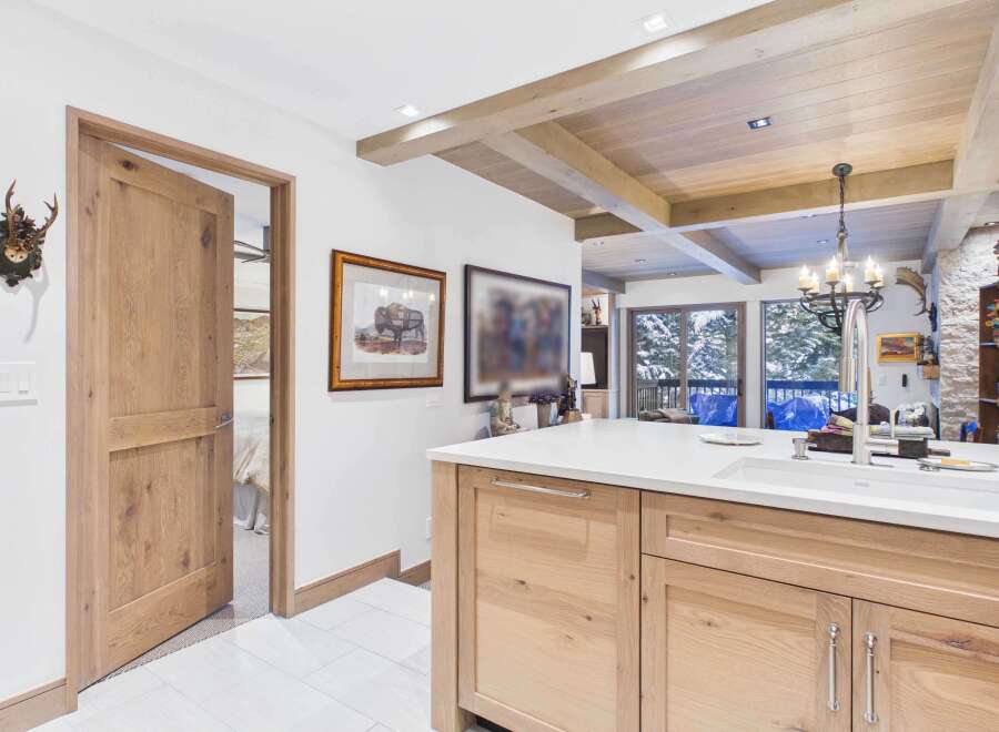 This stunning kitchen boasts a modern design with a rustic touch, featuring a spacious island with a sleek countertop and ample storage.
