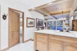 This stunning kitchen boasts a modern design with a rustic touch, featuring a spacious island with a sleek countertop and ample storage.