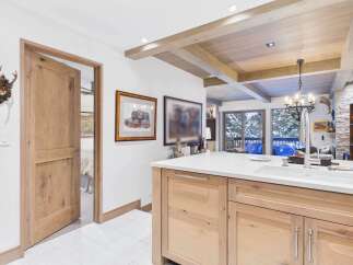 This stunning kitchen boasts a modern design with a rustic touch, featuring a spacious island with a sleek countertop and ample storage.