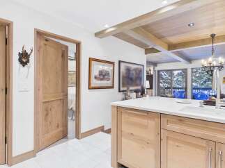 This stunning property boasts a beautifully designed kitchen with custom cabinetry and a spacious island, perfect for culinary enthusiasts.