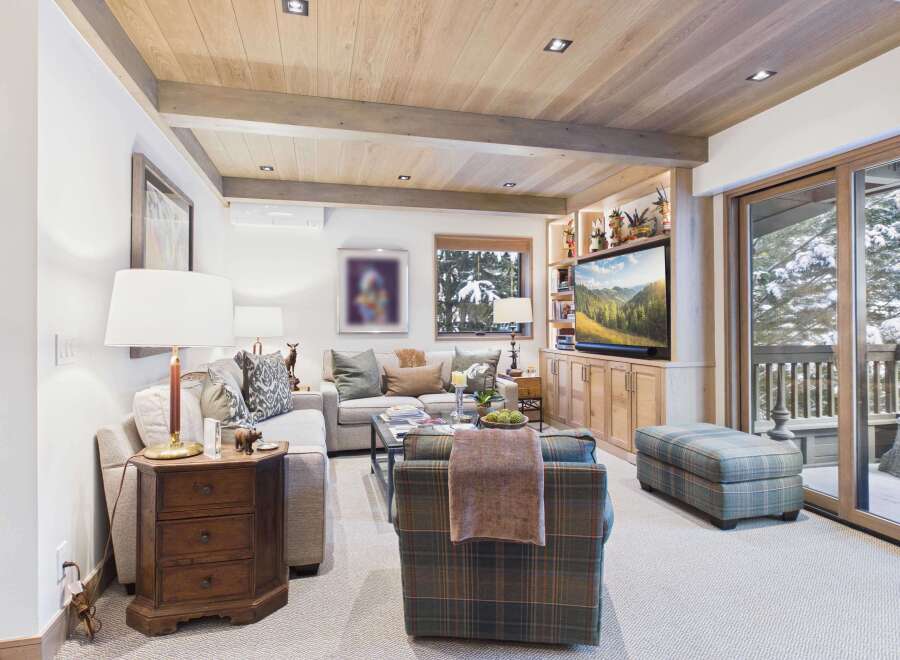 Step into luxury with this stunning living room, featuring a cozy seating area and a built-in entertainment center.