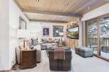 Step into luxury with this stunning living room, featuring a cozy seating area and a built-in entertainment center.