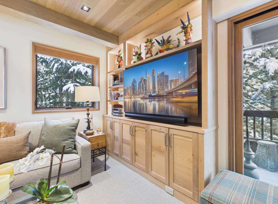 This stunning living room boasts a custom-built entertainment center, perfect for cozy nights in.
