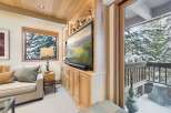 This cozy living space features a built-in entertainment center with a large flat-screen TV and ample storage.
