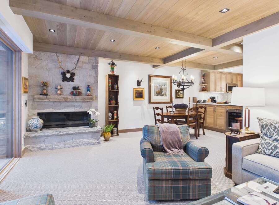 This stunning living space boasts a cozy fireplace, perfect for chilly evenings.