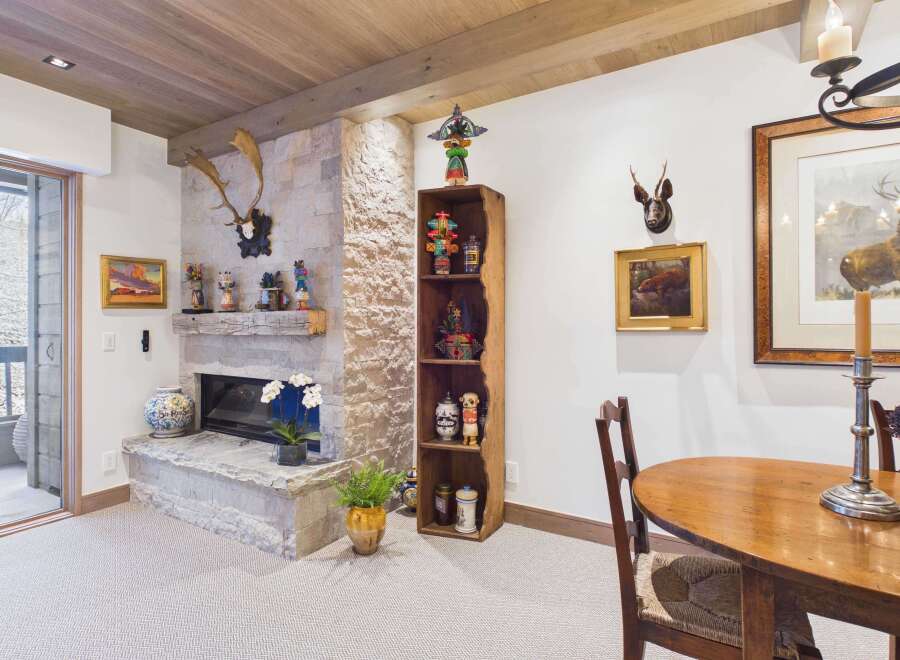 This stunning property boasts a cozy living space with a stone fireplace, perfect for relaxing evenings.