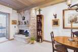 This stunning property boasts a cozy living space with a stone fireplace, perfect for relaxing evenings.