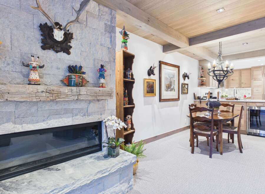 This stunning property boasts a cozy living space centered around a beautiful stone fireplace, perfect for those chilly evenings.