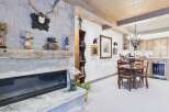 This stunning property boasts a cozy living space centered around a beautiful stone fireplace, perfect for those chilly evenings.