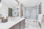 This stunning bathroom boasts a modern design with sleek finishes and ample space.