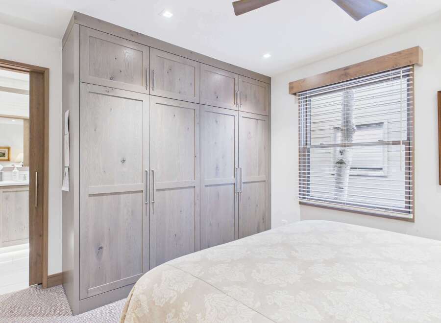 Step into luxury with this stunning bedroom featuring a custom-built closet, offering ample storage and a touch of elegance.