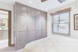 Step into luxury with this stunning bedroom featuring a custom-built closet, offering ample storage and a touch of elegance.
