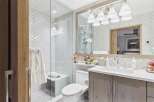 This stunning bathroom features a modern design with a sleek vanity and a luxurious shower.