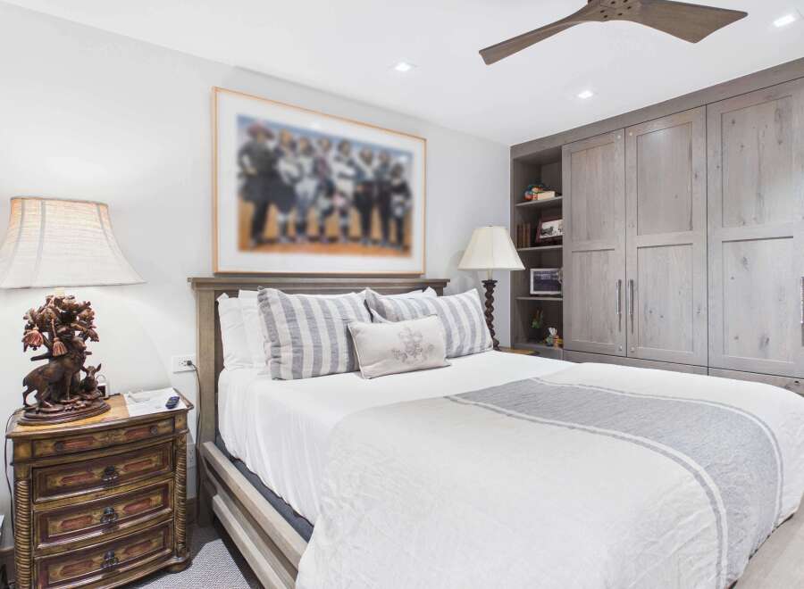 This bedroom offers a serene retreat with its neutral color palette and elegant furnishings.