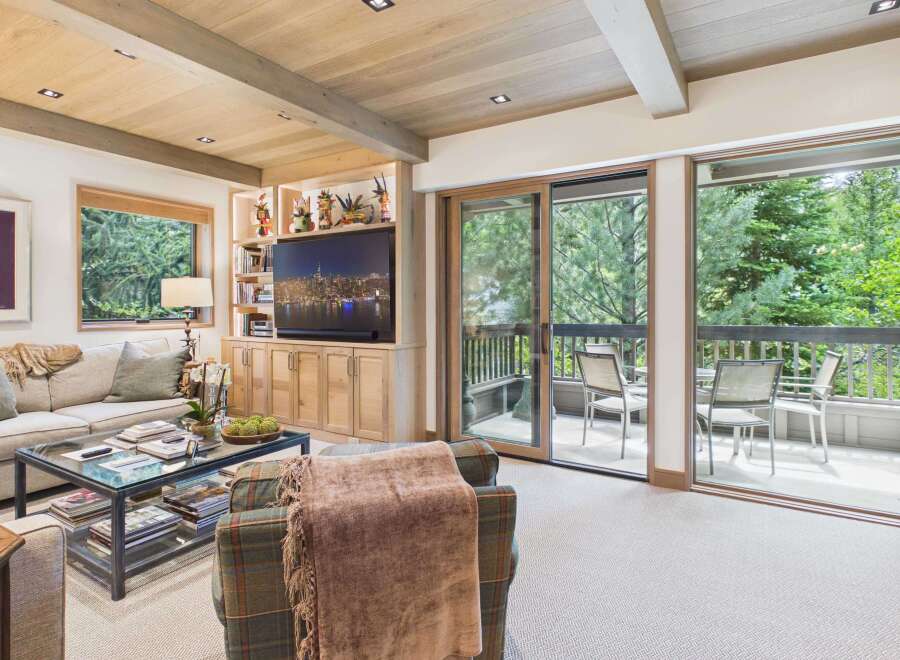 Experience luxurious living in this beautifully appointed living room, featuring a spacious sectional sofa and a stylish glass-top coffee table perfect for entertaining.