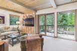 Experience luxurious living in this beautifully appointed living room, featuring a spacious sectional sofa and a stylish glass-top coffee table perfect for entertaining.