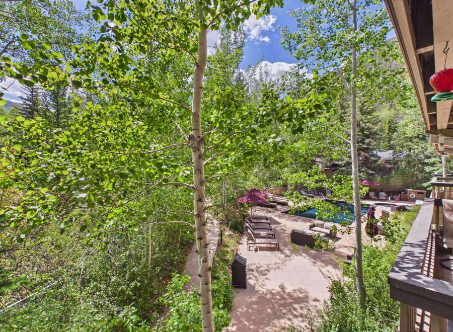 Experience luxury mountain living with this stunning property featuring a private pool and lounge area, perfect for relaxation and entertaining.