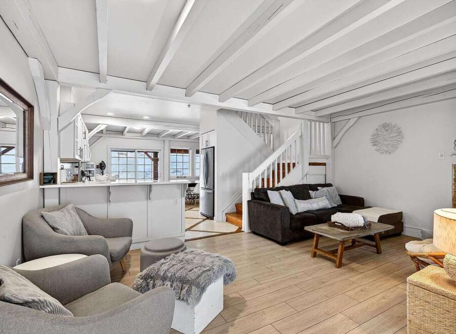 Discover the charm of this beautifully designed home, featuring a bright and airy living space with exposed beams and a cozy fireplace.
