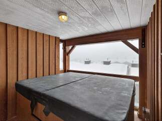 Enjoy breathtaking views from this luxurious property featuring a private hot tub.