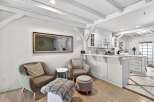 This stunning property boasts a bright and airy interior with exposed beams and a modern kitchen.