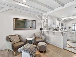 This stunning property boasts a bright and airy interior with exposed beams and a modern kitchen.