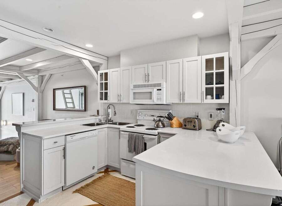This stunning kitchen boasts a bright and airy design, perfect for culinary enthusiasts.