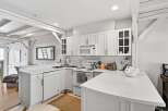 This stunning kitchen boasts a bright and airy design, perfect for culinary enthusiasts.