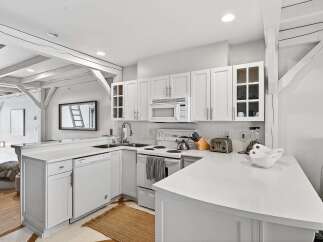 This stunning kitchen boasts a bright and airy design, perfect for culinary enthusiasts.