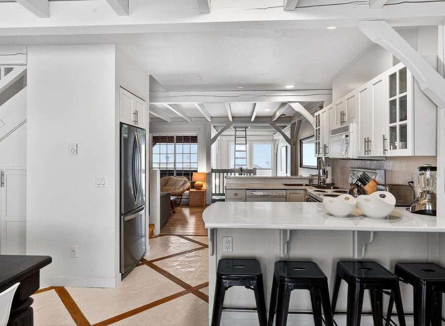 Step into this stunning kitchen, a perfect blend of modern design and coastal charm.