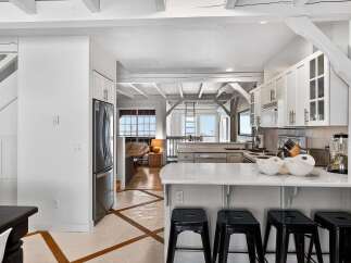Step into this stunning kitchen, a perfect blend of modern design and coastal charm.