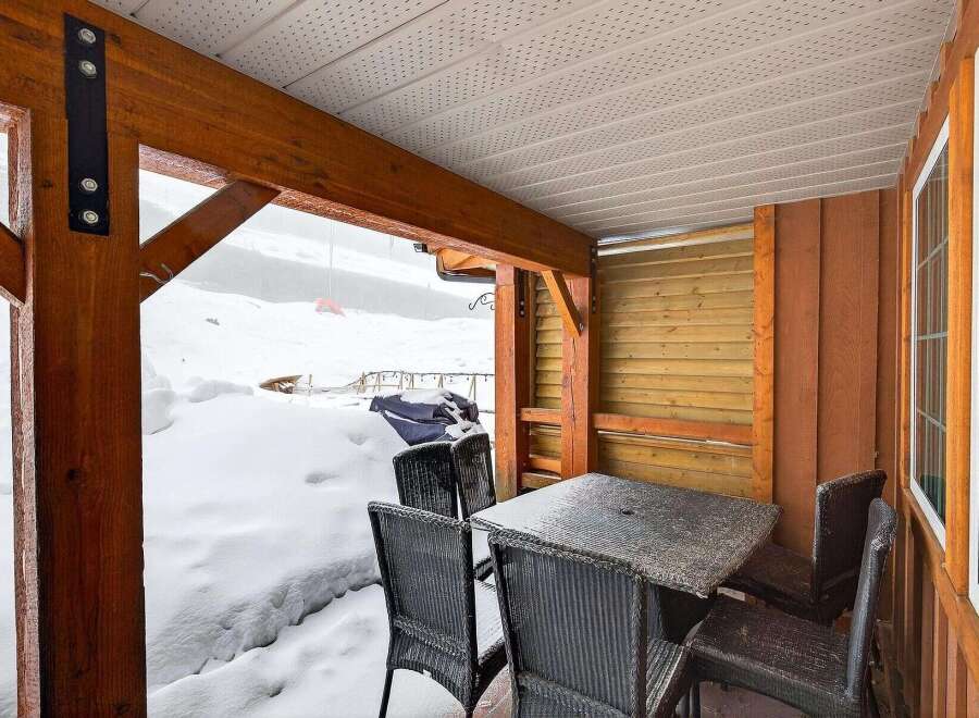 Enjoy the serene beauty of winter from this cozy outdoor space.