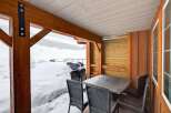Enjoy the serene beauty of winter from this cozy outdoor space.