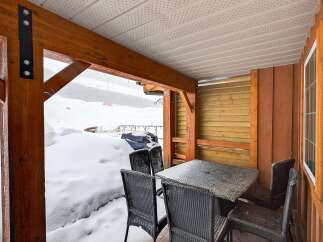 Enjoy the serene beauty of winter from this cozy outdoor space.