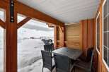 Enjoy the serene beauty of winter from this cozy outdoor space.