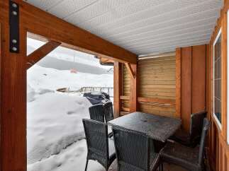 Enjoy the serene beauty of winter from this cozy outdoor space.