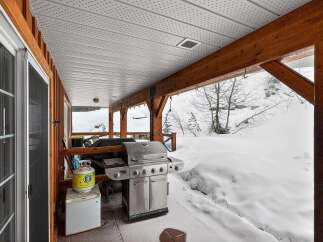 Enjoy outdoor cooking in style with this stunning property featuring a covered patio and a built-in grill.