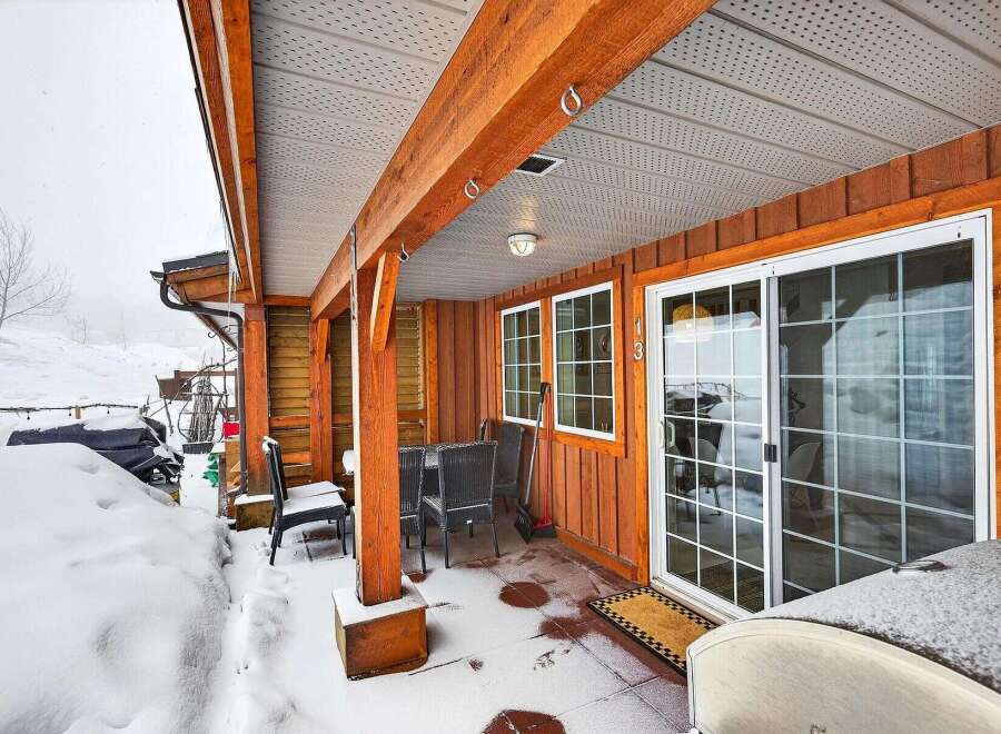 This charming property boasts a cozy covered patio, perfect for enjoying the outdoors even in winter.