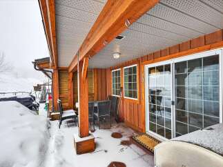 This charming property boasts a cozy covered patio, perfect for enjoying the outdoors even in winter.