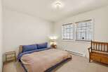 This cozy bedroom features a comfortable bed with a stylish duvet cover and pillows.