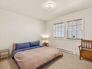 This cozy bedroom features a comfortable bed with a stylish duvet cover and pillows.