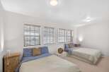 This cozy bedroom features two twin beds, perfect for guests or roommates.