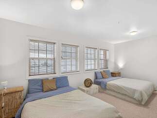 This cozy bedroom features two twin beds, perfect for guests or roommates.