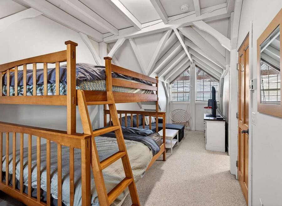 This charming bedroom features a cozy bunk bed, perfect for accommodating guests or family members.