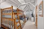 This charming bedroom features a cozy bunk bed, perfect for accommodating guests or family members.