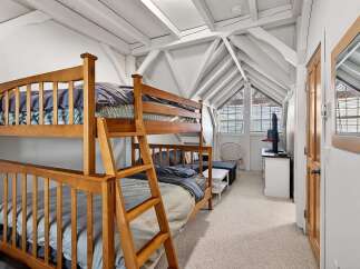 This charming bedroom features a cozy bunk bed, perfect for accommodating guests or family members.