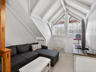Discover the charm of this unique property! This cozy living space features a stylish sectional sofa, perfect for relaxing.
